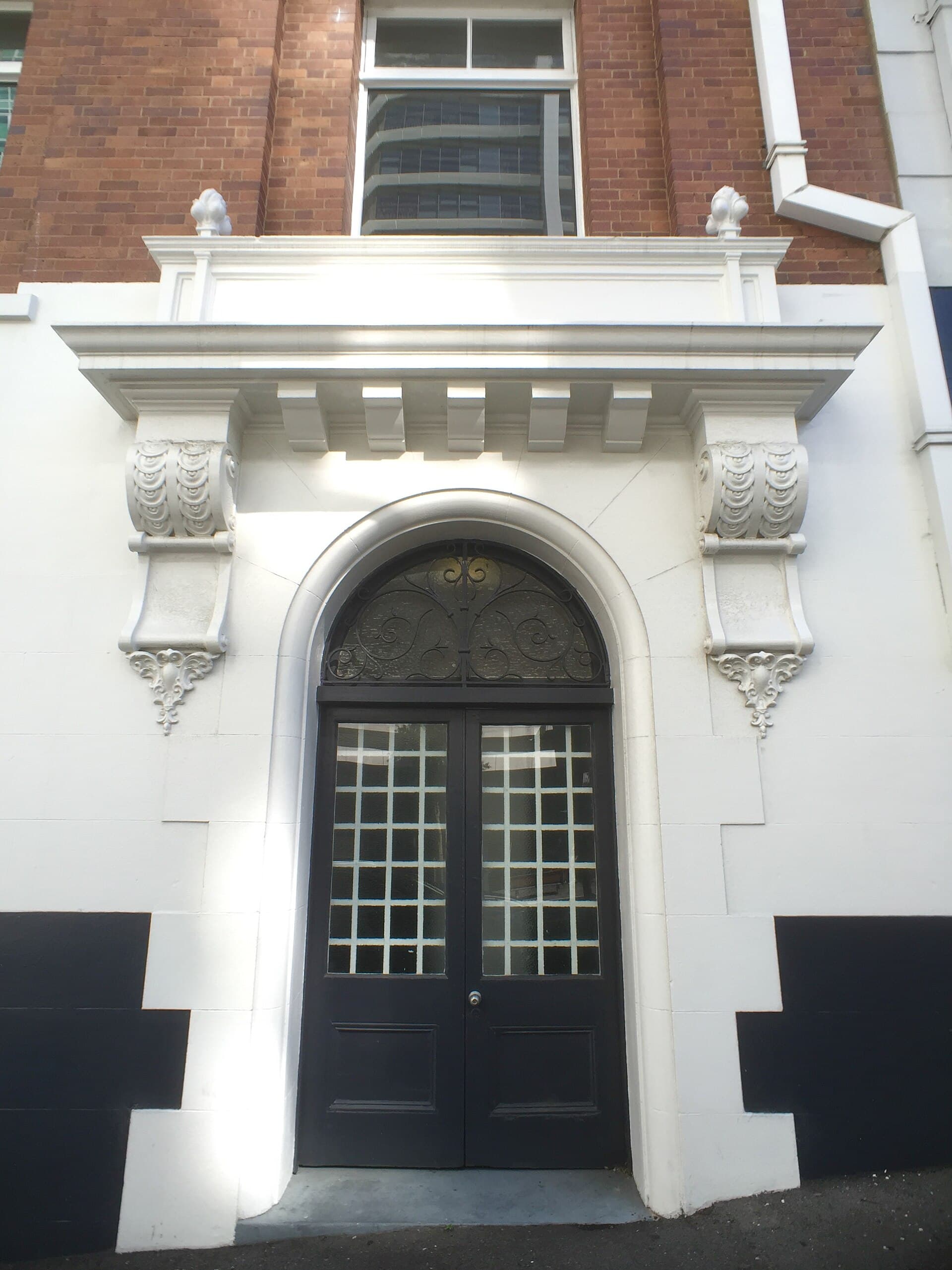 Tall timber entrance door with fanlight on Adelaide Street, Brisbane