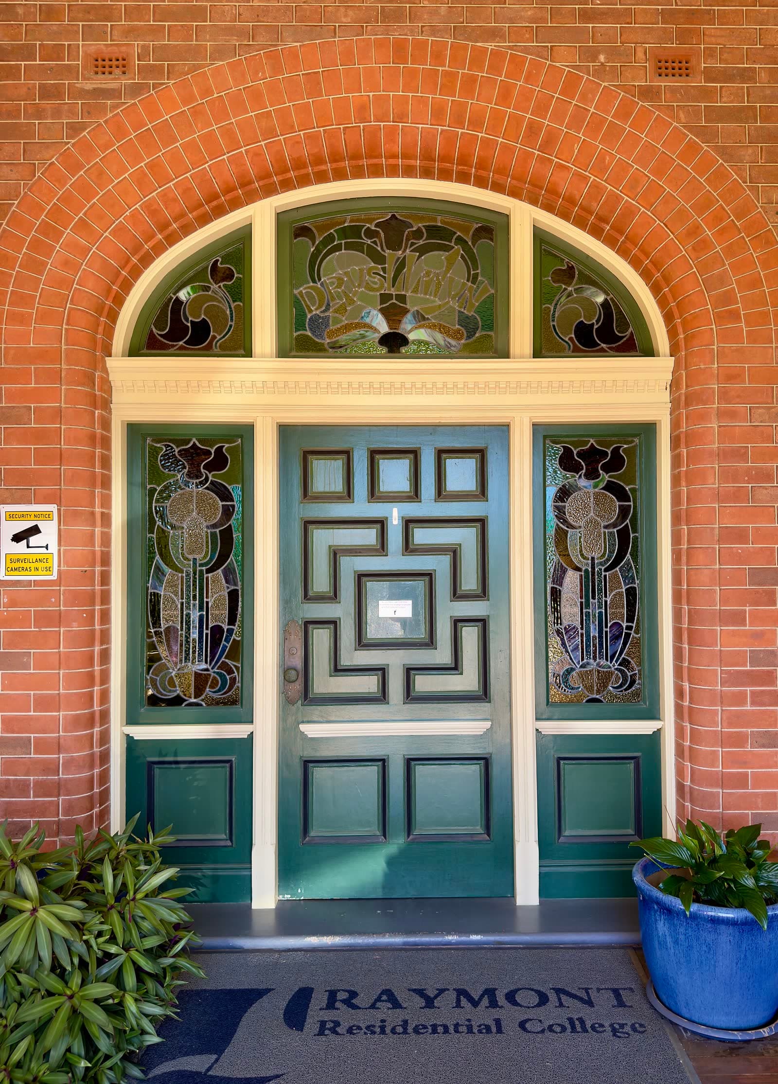 Heavy timber entrance door with stained-glass sidelights at Drysllwyn, Auchenflower, Brisbane