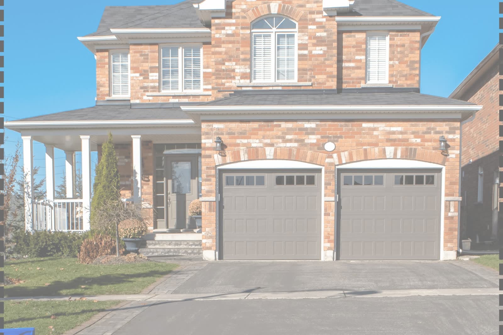 White sectional garage door on a suburban house