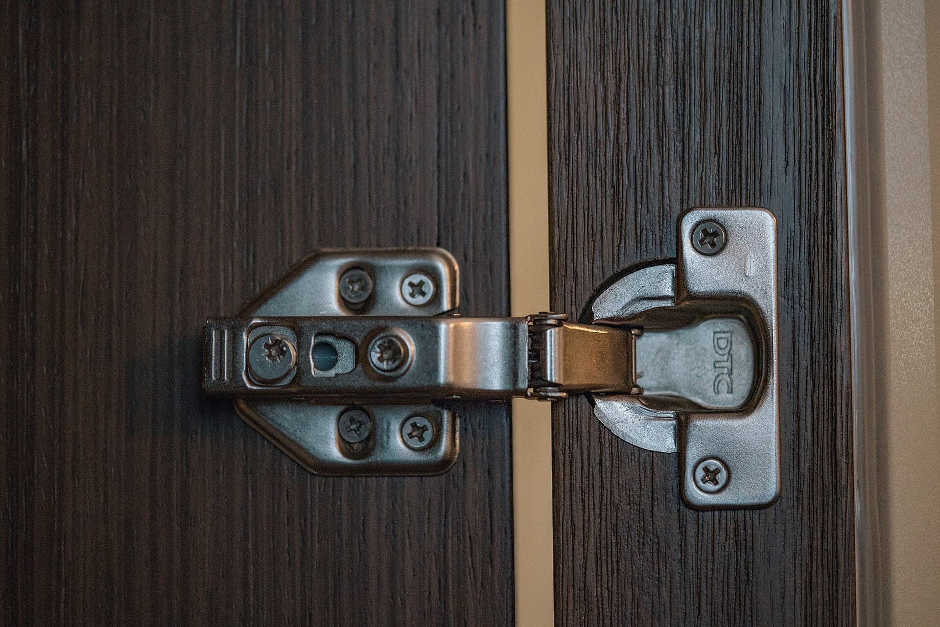 Soft-close hinge and closer hardware on a timber door edge